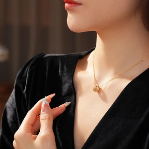 Close-up of 18K gold plated circle necklace with pavé zircon stones on a model