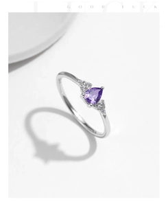 Detailed macro view of pear-cut purple amethyst and white diamonds on s925 silver ring