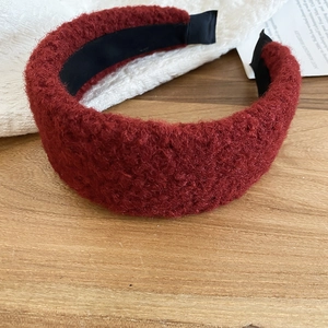 Detail view of thick wine red plush sponge headband with a soft faux lamb wool texture