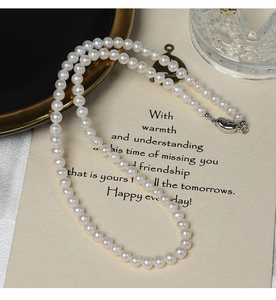 Detailed view of 5-6mm white freshwater pearls on a 925 sterling silver necklace