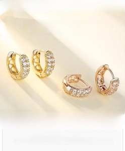 Detail showing double-row cubic zirconia inlay on classic gold-plated hoop earrings