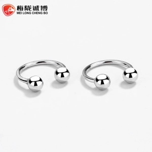 Macro shot of silver horseshoe stud earrings with polished sphere ends on white background