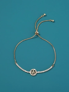 Macro detail of golden tree of life bracelet with sparkling micro-set cubic zirconia stones