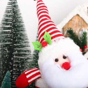 Detail of Santa Claus plush doll with red and white knit hat for Christmas decor