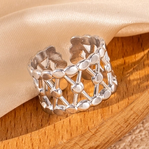 Macro shot showing silver hollow geometric leaf design on polished stainless steel ring