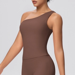 Detail of chocolate brown one-shoulder sports bra with matte high-elasticity fabric