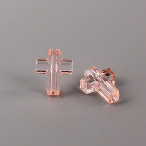 Macro shot of transparent pink crystal cross beads with precision drill holes for DIY jewelry