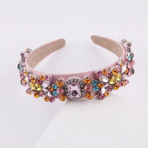 Detailed macro view of colorful rhinestones and pink gems on a velvet baroque headband