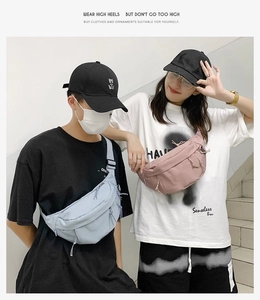 Street style couple wearing light blue and pink minimalist nylon crossbody bags