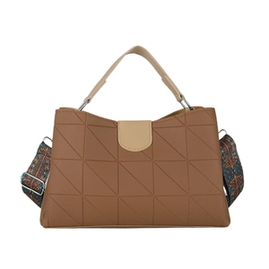Brown PU handbag with geometric quilting and ethnic patterned wide strap on white background