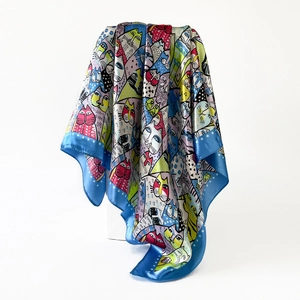 Detailed shot of satin scarf featuring colorful cartoon cat prints and blue polka dot edges