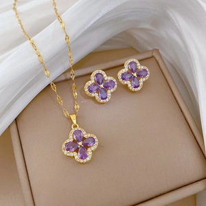 Detail view of titanium steel necklace and earrings set with purple amethyst clover pendant