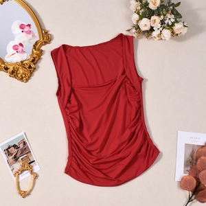 Detail of red square neck tank top featuring side ruched elastic fabric on flat lay background