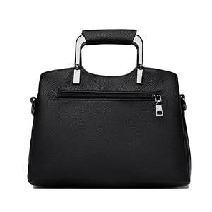 Minimalist black pebble grain leather tote bag with silver hardware on white background
