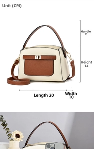 Detailed view of bicolor crossbody bag with dimensions 20x10x14cm and golden metal twist lock