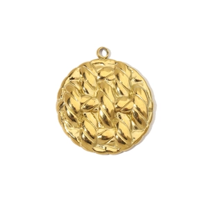 Macro shot of a vintage gold-plated round pendant with 3D braided texture and top loop