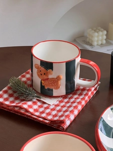 Detail of a ceramic coffee mug featuring a 3D brown dog relief and black stripes