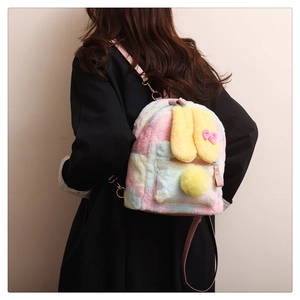 Close-up of plush rabbit backpack with pink bow, colorful fur and gold buckle straps