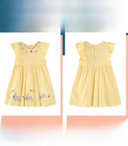 Detailed view of yellow cotton girls' dress with bunny embroidery and polka dots