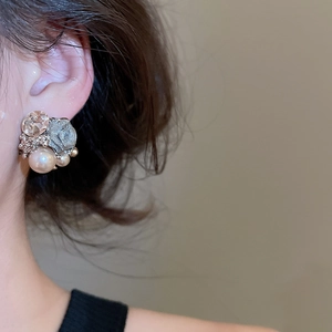 Detailed view of silver flower earrings with champagne pearls and sparkling crystals