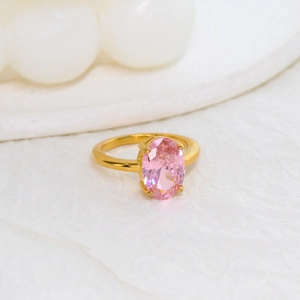 Close-up of elegant oval pink zircon stone set in gold-plated stainless steel ring