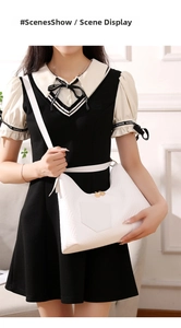 Detail of white quilted hobo bag featuring V-shaped texture and gold zipper hardware