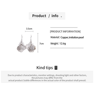 Detail view of hollow mesh petal earrings with imitation pearls and size measurements