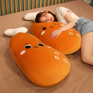 Close-up of a large cartoon chicken leg plush pillow featuring a cute face design