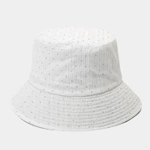 Detail of white bucket hat with silver polka dots and premium textured cotton fabric