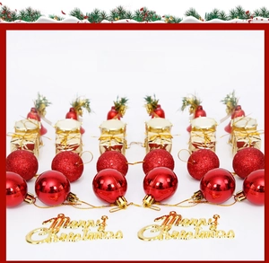 Detail of red glitter balls, gold gift boxes, and bells for Christmas tree decoration