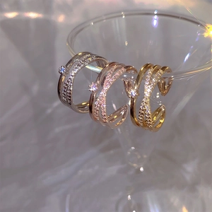 Double-layered crisscross rings in silver, rose gold and gold with cubic zirconia stones