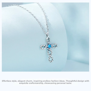 Macro shot of silver cross necklace pendant featuring turquoise stone and infinity rope texture