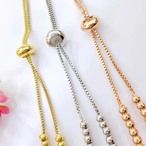 Detailed view of adjustable 18k gold plated bead slider chains in gold silver and rose gold