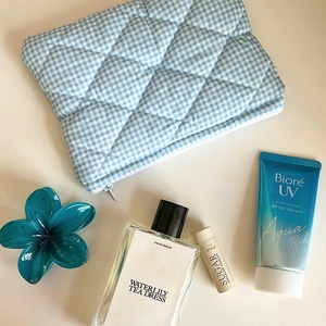 Blue and white checkered quilted cosmetic bag with zipper for travel organization