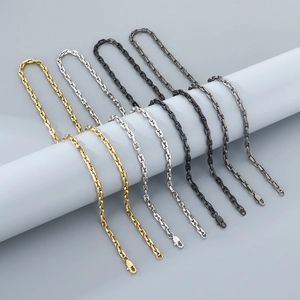 Detail showing high-quality anchor link chains in gold, silver, black, and dark gray steel