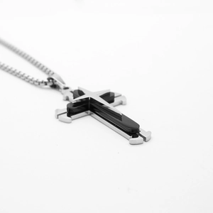 Close-up of three-layer cross pendant with silver chain and black enamel hip-hop detail