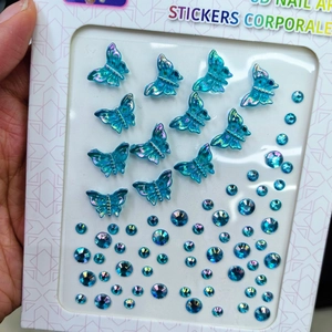 Detailed view of 3D iridescent blue butterfly stickers and gems for face and nails