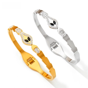 Detailed view of snake head bangles with sparkling crystals and secure snap closures
