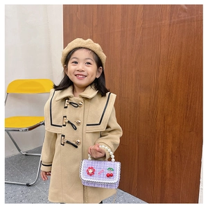 Detailed texture of girls beige wool coat with stylish buttons and elegant lapel