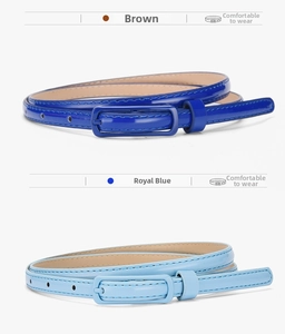 Detail view of thin patent leather belts in royal blue and sky blue with pin buckles