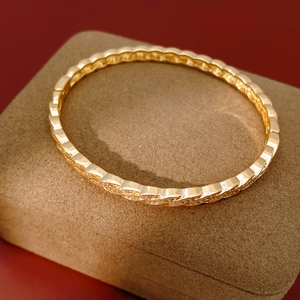 Detailed macro view of gold-plated twisted rope bracelet featuring pave-set cubic zirconia