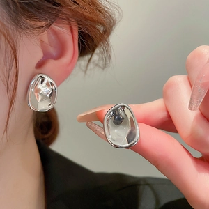 Minimalist irregular liquid metal stud earrings in silver for a modern chic aesthetic