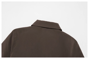 Detail of the back neckline and neat stitching on a brown windproof outdoor jacket