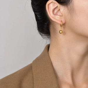 Elegant gold-plated hoop earrings with small spherical pendant charms for women