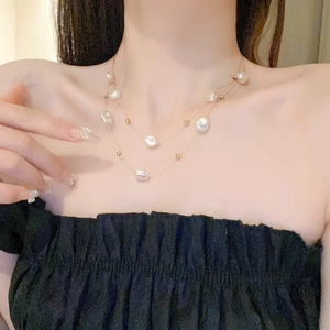 Close-up of double-layer stainless steel necklace with baroque pearls on model