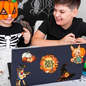 Close-up of Halloween gnome and pumpkin magnetic stickers applied on a laptop case