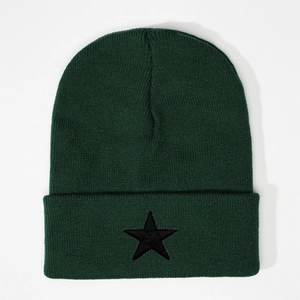 Close-up of black star embroidery on the forest green ribbed knit winter beanie hat