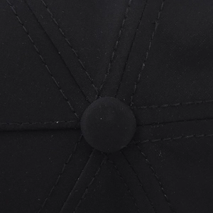Close-up of the black twill fabric crown and stitched top button on the baseball cap