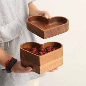 Macro shot of heart-shaped wooden snack box with stackable layers and natural grain