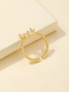 Detail of gold twisted band ring with three sparkling marquise-cut zircon stones